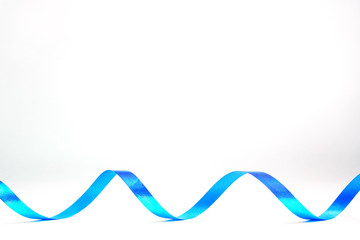 Blue curling ribbon for gift wrapping art and crafts on white background. Copy space
