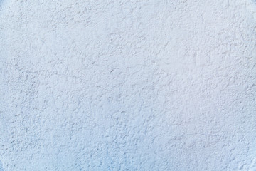 Background of grey painted embossed wall with cracked rough finish. Backgrounds texture design.