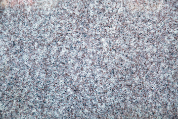 Background of grey painted embossed wall with cracked rough finish. Backgrounds texture design.