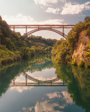 San Michele bridge over Adda with reflections