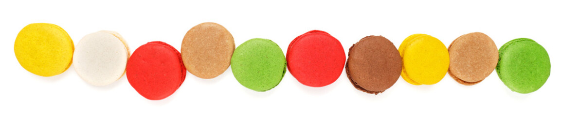 Banner of colored macarons on a white background. Sweet background of multi-colored biscuits.