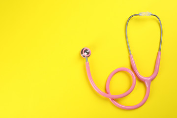 Stethoscope with space for text on color background, top view. Medical tool