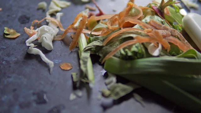 vegetable scraps food waste on kitchen board, cabage, carot, lettice, cucumber