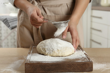 Female baker preparing bread dough at table, closeup