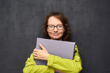 Portrait of young woman holding big folder