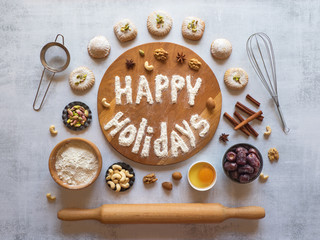 Happy holidays food background. Egg, flour and nuts are laid out on a light table.