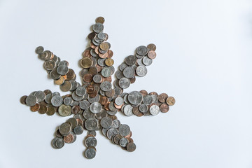 Marijuana leaf made of US American coins on solid white background