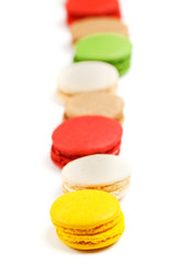 Macaroon row on a white background. Sweet pastries with food dyes.
