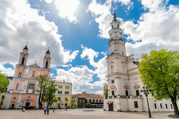 Naklejka na ściany i meble Town Hall White Swan in the center of Kaunas at the Town Hall Square in Lithuania in the spring against a blue sky with cirrus clouds. Kaunas, Lithuania – May, 2019
