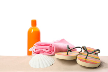 Different stylish beach accessories on sand against white background