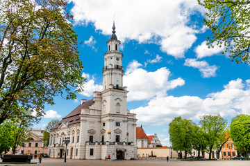 Town Hall White Swan in the center of Kaunas at the Town Hall Square in Lithuania in the spring against a blue sky with cirrus clouds - obrazy, fototapety, plakaty