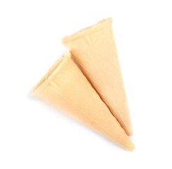 Naklejka premium Empty crispy waffle cones for ice cream on white background, top view
