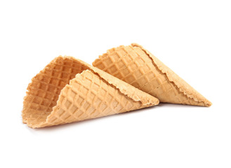 Empty crispy waffle cones for ice cream on white background