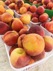 Fototapeta na wymiar Fresh Georgia Peaches for Sale at a Farmers Market