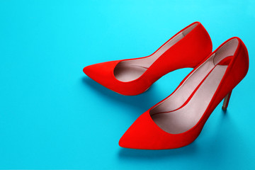Pair of stylish shoes on colorful background. Space for text