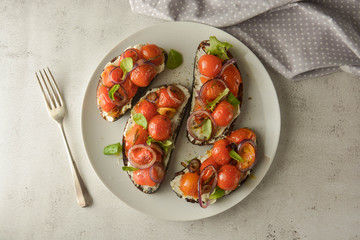 Vegan sandwiches, bruschettas with cheese cream and cherry tomatoes. Whole bread slices.