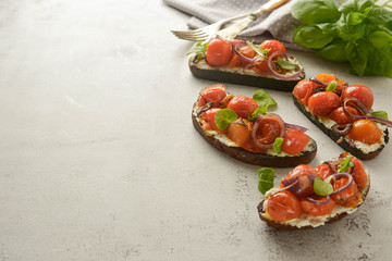 Bruschetta with cherry tomatoes and cheese cream. Healthy, vegan food, snack.