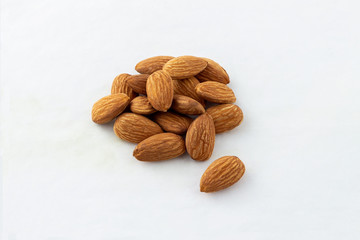 group of almonds without shells on white background