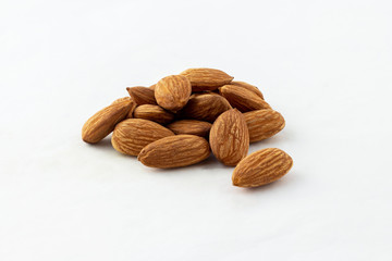 group of almonds without shells on white background
