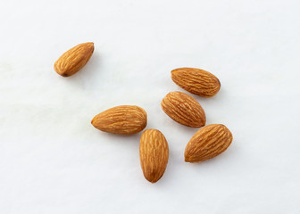 group of almonds without shells on white background