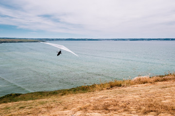 Hang glider just after take off on the cliff of Kervijen in Brittany France