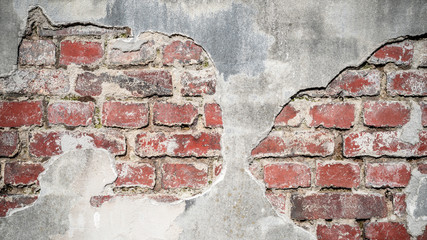 Old, plastered red brick wall with broken plaster as background or texture