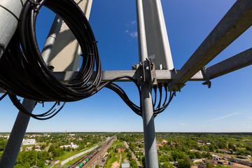 Telecommunication tower or mast with microwave, radio panel antennas, outdoor remote radio units,...