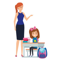 student girl in school desk with female teacher