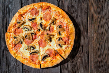 Top view delicious fresh pizza with tomatoes, mushrooms and cheese
