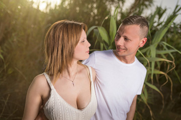 Happy moments together. Happy young couple embracing and smiling while looking each other