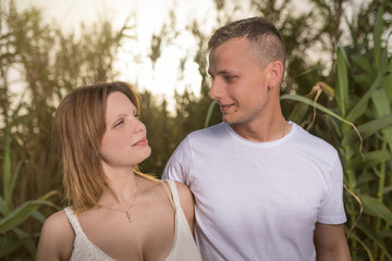 Loving man and happy woman in a spring blooming park. Happy mature couple in love embracing outdoor, looking each other