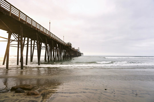 Fototapeta OCEANSIDE, CALIFORNIA - 1 JUNE 2019: Oceanside view and pier bridge playground