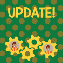 Text sign showing UPDATE. Business photo showcasing make something more modern or up to date like software program Two Business People Each Inside Colorful Cog Wheel Gears for Teamwork Event