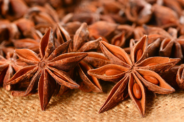 Star anise. Some star anise fruits with seeds 7. Macro close up on the jute burlap canvas.