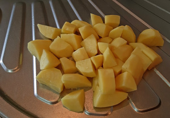 Potatoes cut into slices in the kitchen