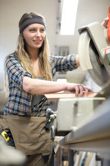 young woman working in carpenter's workshop