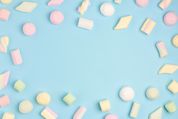 Marshmallows on blue background. Cozy sweet background
