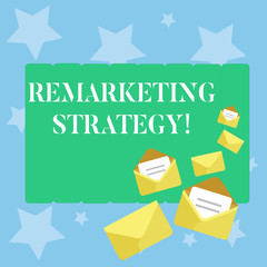 Handwriting text writing Remarketing Strategy. Conceptual photo reengage customers using information collected Closed and Open Envelopes with Letter Tucked In on Top of Color Stationery