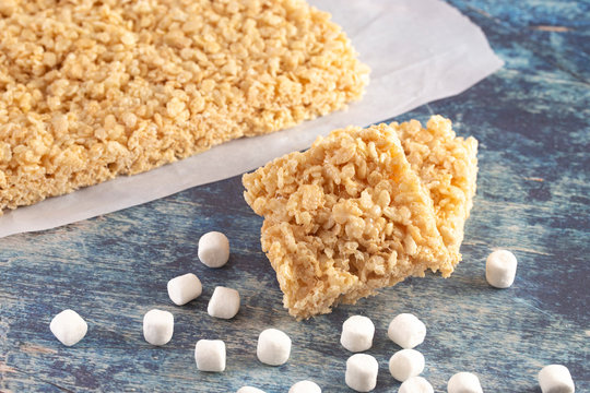  Marshmallow Crispy Rice Cereal Treat Bars on a Wooden Table