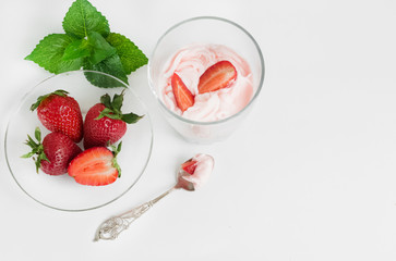 Delicious strawberry ice cream scoop with fresh strawberries on wooden background