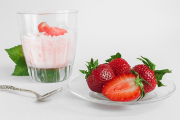 Delicious strawberry ice cream scoop with fresh strawberries on wooden background