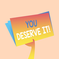Handwriting text writing You Deserve It. Conceptual photo should have it because of their qualities or actions Hand Holding and Raising Blank Space Colorful File Folder with Sheet Inside