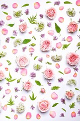 Vertical flower pattern: roses, hawthorn flowers, rowan leaves on a white background. Top view