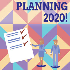 Conceptual hand writing showing Planning 2020. Concept meaning process of making plans for something next year Man and Woman Presenting Report of Check and Lines on Paper