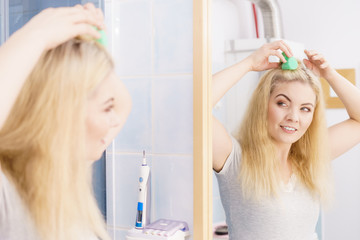 Blonde woman using hair rollers