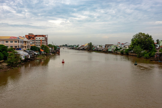 A landscape pictures of the shores of the mekong river in south vietnam near vinh long on a sunny summer day.