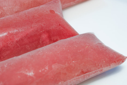 frozen sweet brazilian ice candy, name geladinho, chupchup, sacole or dindin, made with Strawberry - ice cream in the bag