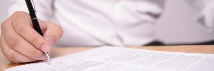 Wide View of Businessman Signing Contract