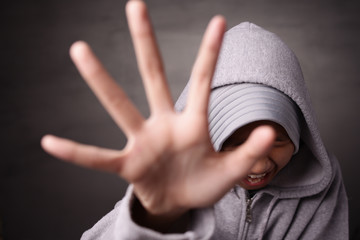 Little Muslim girl shows her hand asking to stop. Children Violence