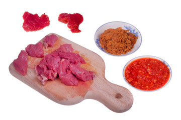 Appetizing red fresh veal, sliced into raw thin beef, chili and coconut fried or Kerisik  isolated   on white background